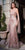 A slender Caucasian brunette female is wearing a Rose Gold Glitter Strapless Mermaid Gown with long ribbon shoulder straps made of tulle. This style CB093 by Cinderella Divine and sold by Betty Glam Boutique . Perfect for Pageant, Wedding Guest, Lavish Dinner Dates, Marine Ball, Red Carpet and so much more!